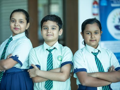 Three students in school uniform standing together